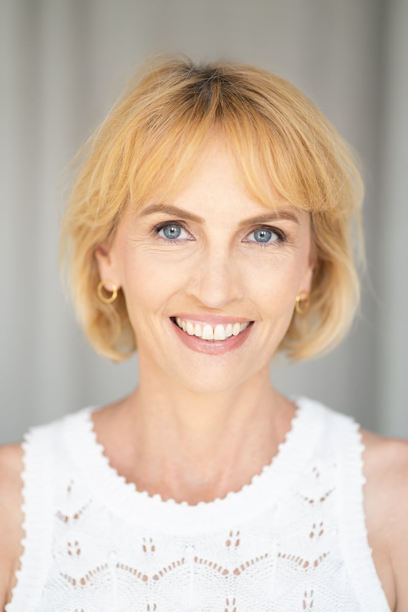 Author and psychotherapist Tonya Lester smiling in a white top