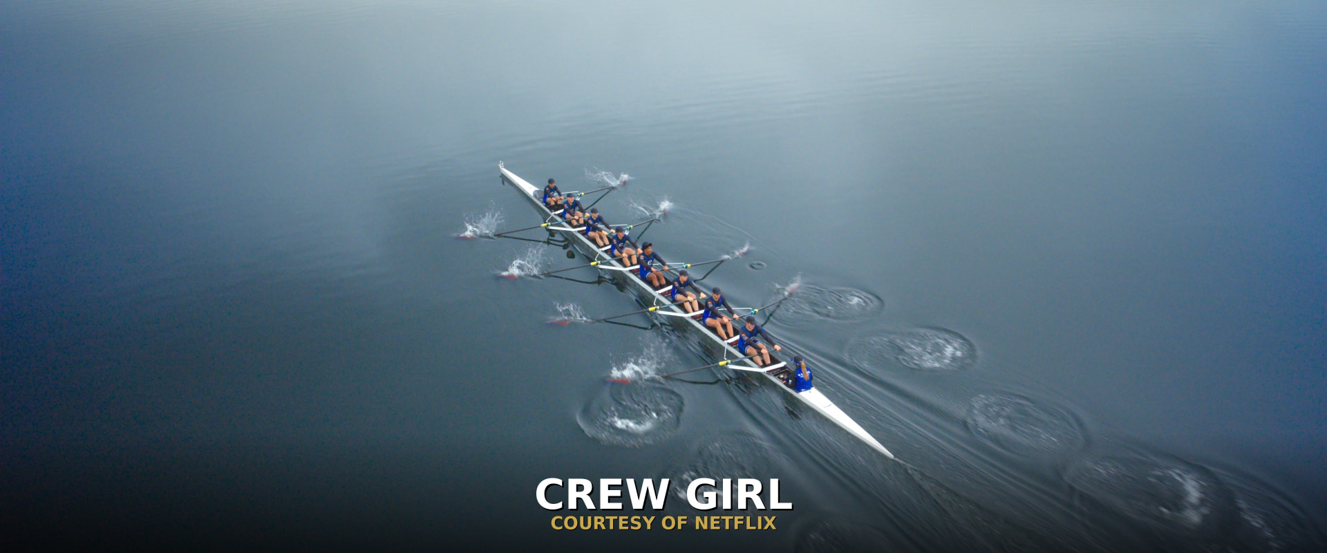 The Crew Girl rowing team racing across calm water, courtesy of Netflix