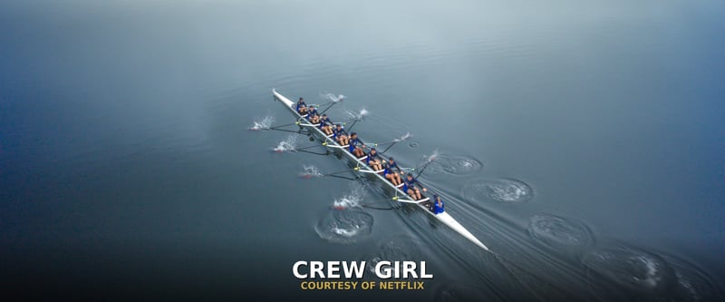 The Crew Girl rowing team racing across calm water, courtesy of Netflix