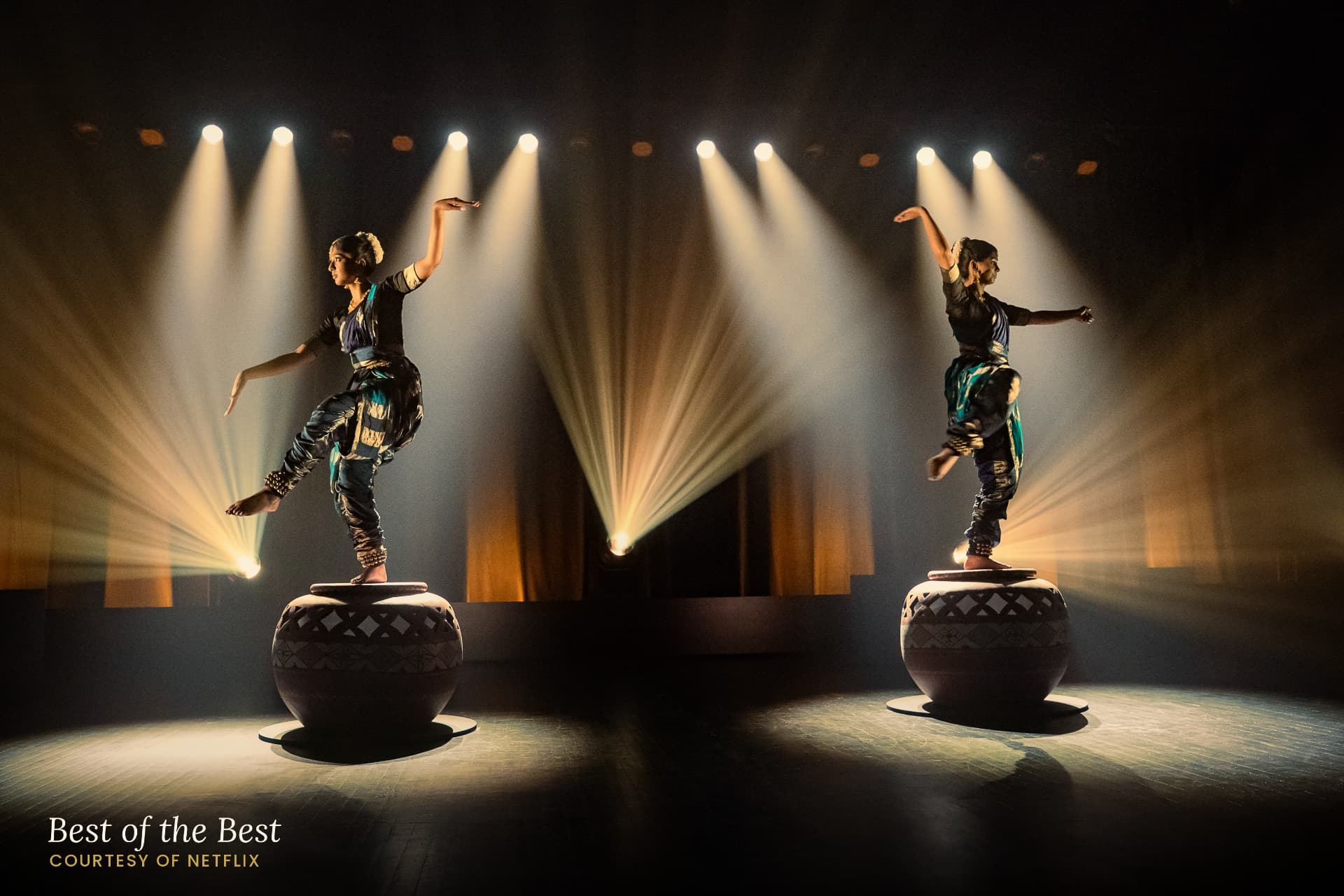 Maya and Anjali performing beneath stage lights in Best of the Best, courtesy of Netflix