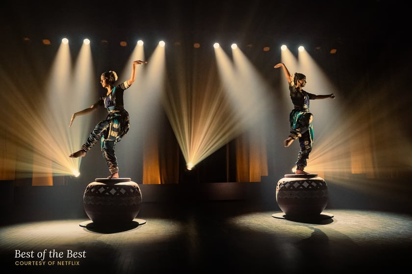 Maya and Anjali performing beneath stage lights in Best of the Best, courtesy of Netflix