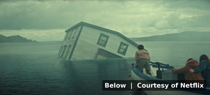 The Penney family approaching a half submerged house in Netflix's Below, courtesy of Netflix