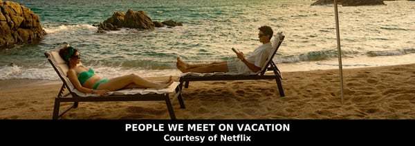 Poppy and Alex relaxing on sun loungers by the sea in People We Meet on Vacation, the Emily Henry adaptation streaming on Netflix, image courtesy of Netflix