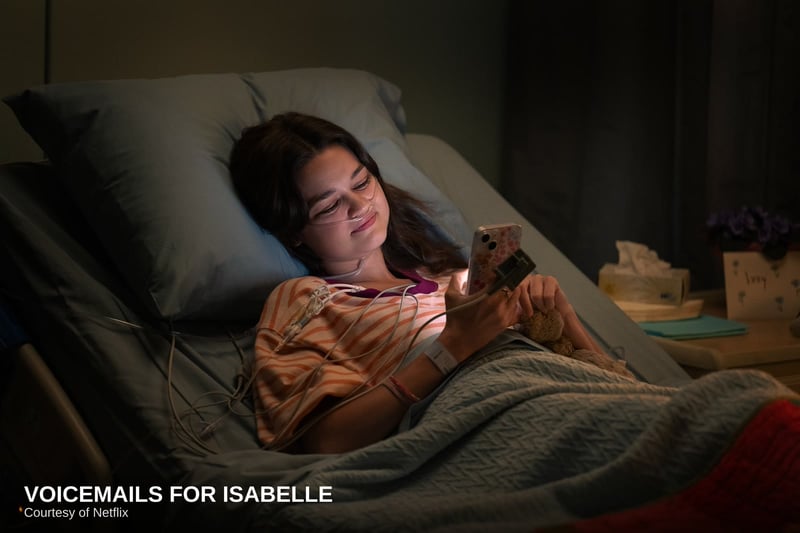 Zoey Deutch as Jill on a hospital bed, phone in hand, in Voicemails for Isabelle, courtesy of Netflix